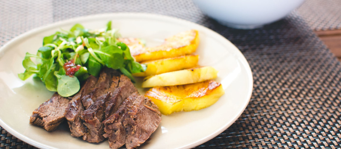 Beef steak with grilled pineapple and salad